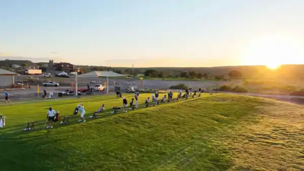 golfers on driving range at new mexico open turtleback mountain golf and resort